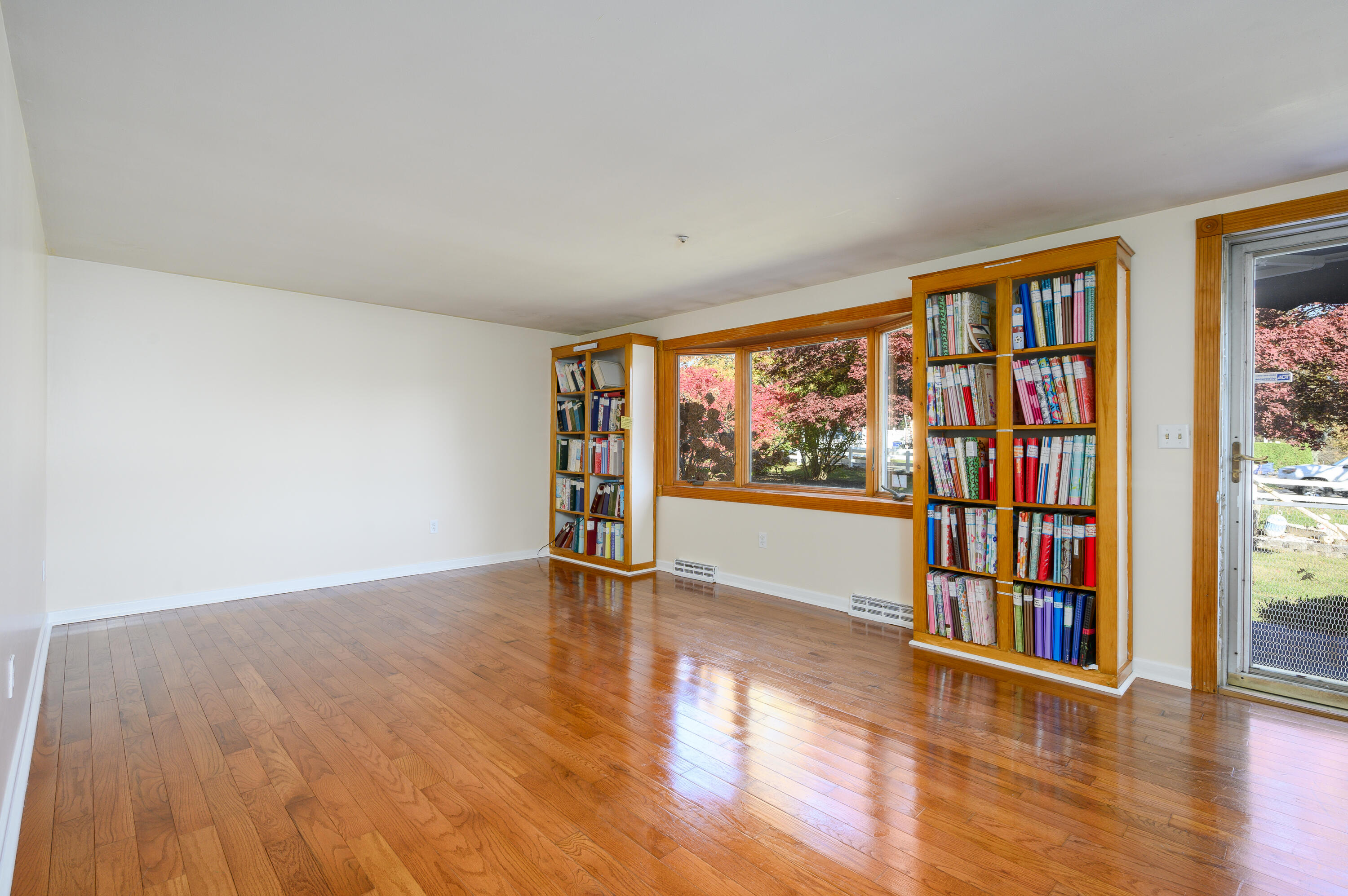 906 Shore Road Pocasset, MA 02559 - Photo 4 of 38 a view of an empty room with window and wooden floor