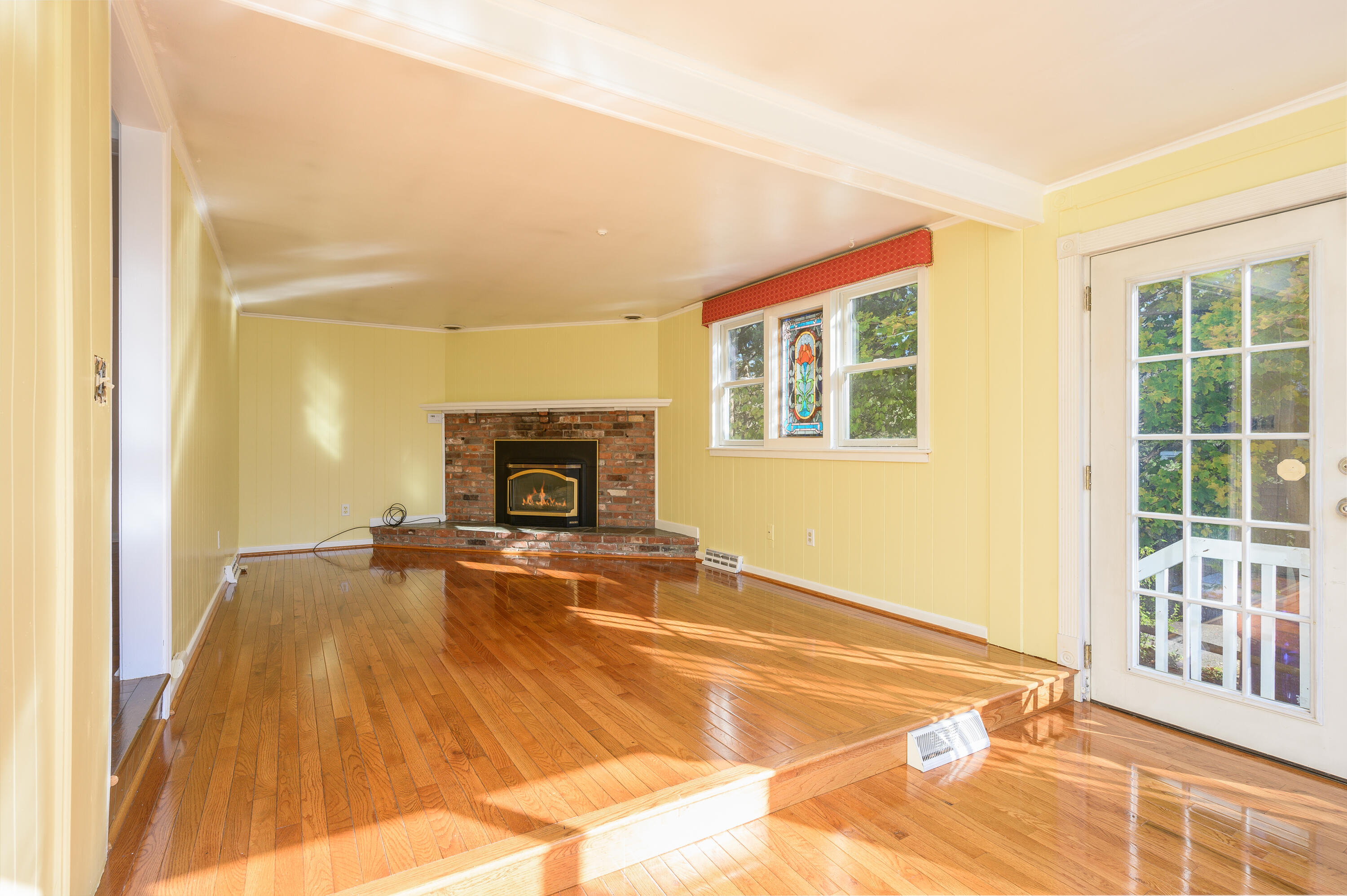 906 Shore Road Pocasset, MA 02559 - Photo 10 of 38 a view of an empty room with a fireplace and a window