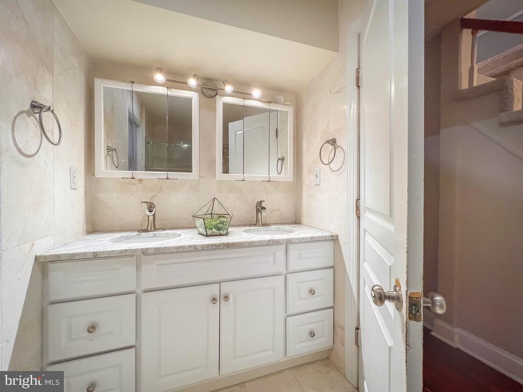 10 Makefield Road Morrisville, PA 19067 - Photo 17 of 46 a bathroom with a double vanity sink and a mirror