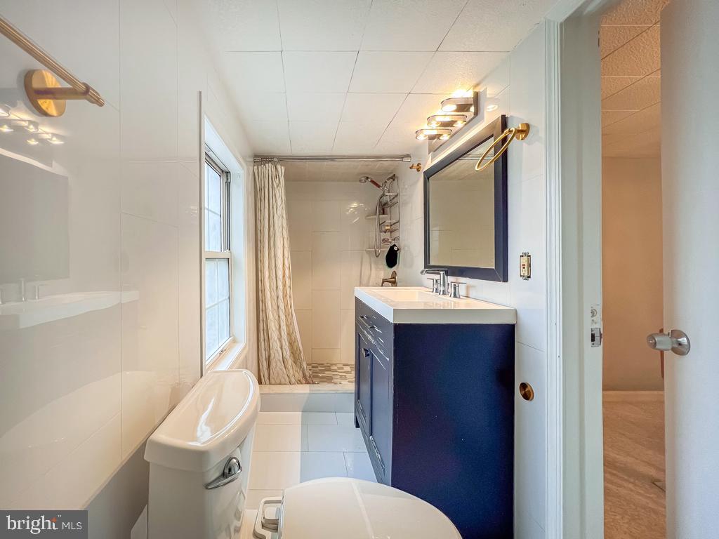 10 Makefield Road Morrisville, PA 19067 - Photo 30 of 46 a bathroom with a sink vanity mirror and toilet