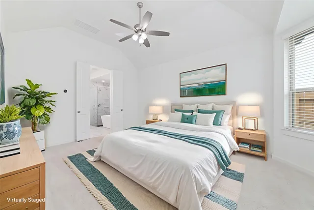 a bedroom with a bed and a potted plant