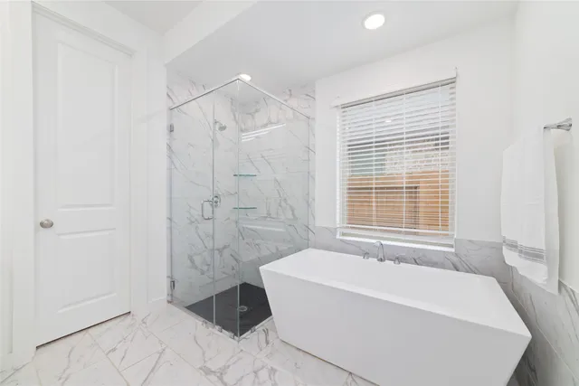 a bathroom with a bathtub and shower