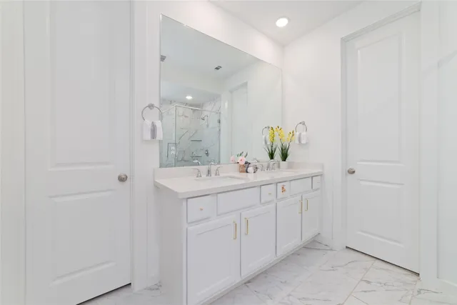 a bathroom with a double vanity sink and a mirror