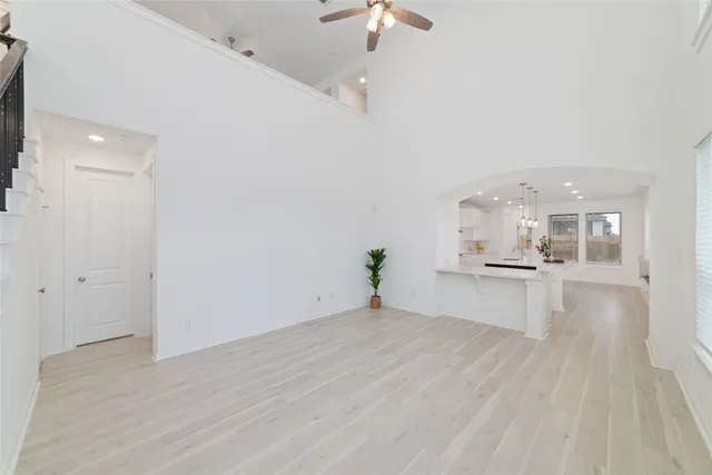 a view of a kitchen with kitchen island a sink wooden floor and a counter top space