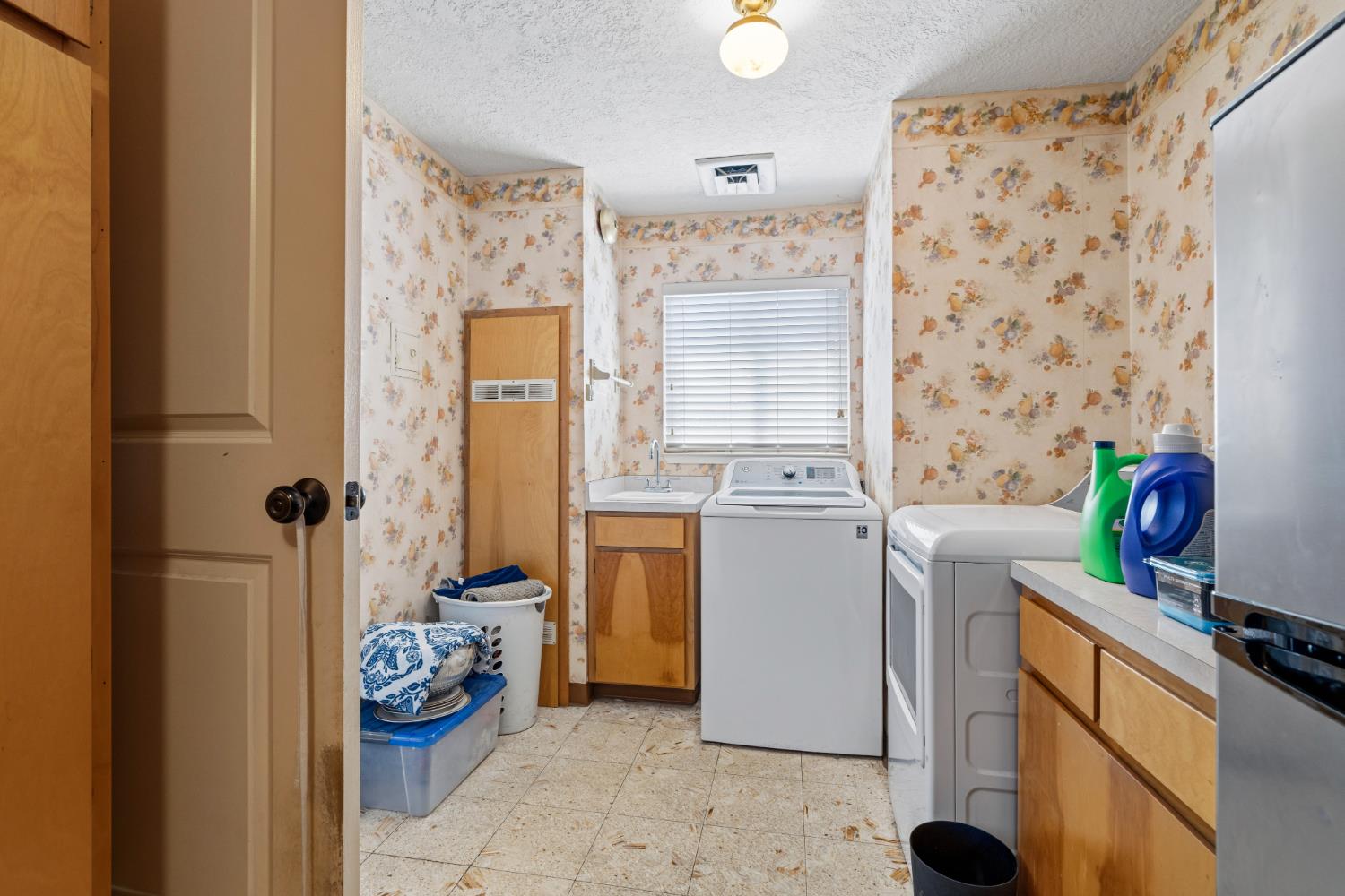 231 South Austin Road Manteca, CA 95336 - Photo 23 of 39 Extra large laundry room with lots of cabinets and shelves.