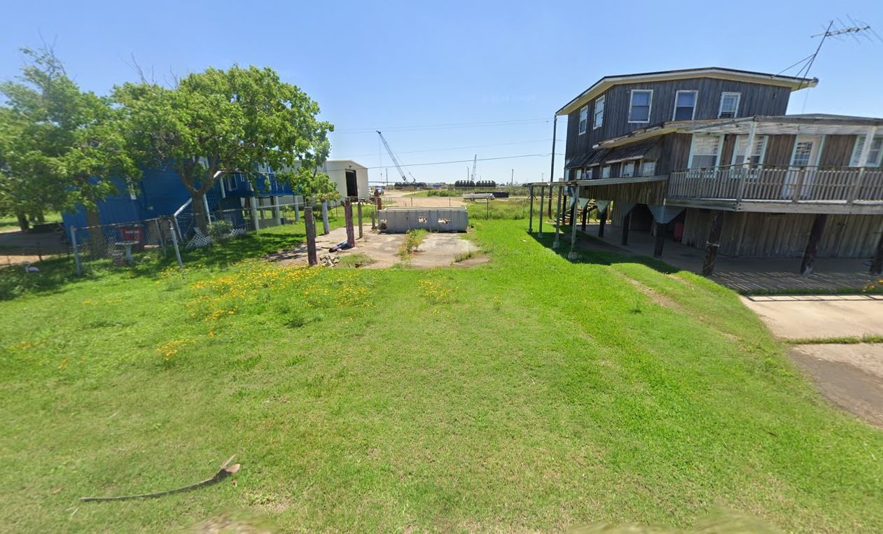 a view of a house with a yard and sitting area