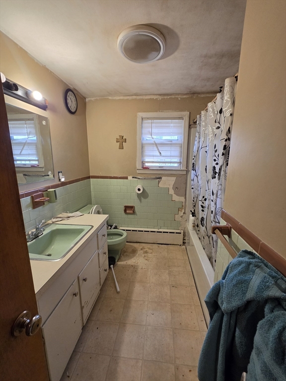 3 Hampton Street Worcester, MA 01604 - Photo 5 of 13 a bathroom with a granite countertop sink a toilet and bathtub