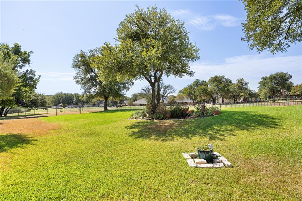 8712 Bellechase Road Granbury, TX 76049 - Photo 33 of 37 Watch the golfers and enjoy this low maintenance back yard with mature trees