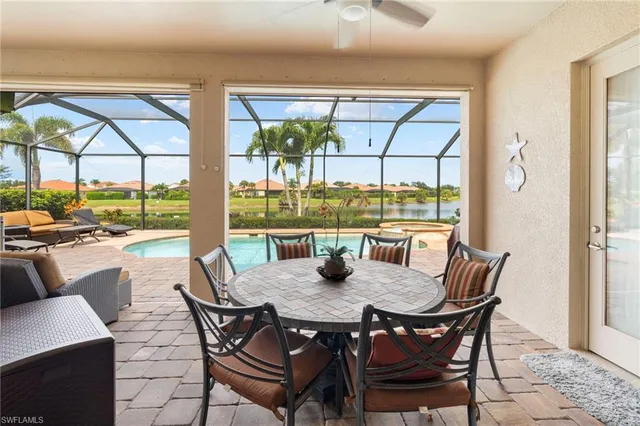 a view of a dining room with furniture large windows and wooden floor