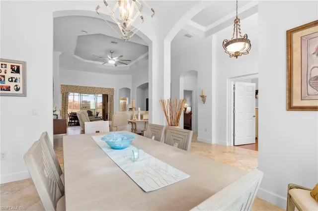 a dining room with furniture a chandelier and window