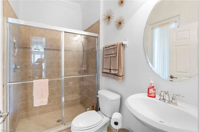 a bedroom with a bed and a flat tv screen on dresser