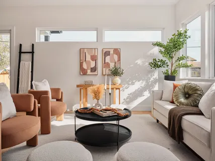 a living room with furniture and a potted plant