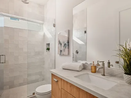 a bathroom with a shower sink and mirror