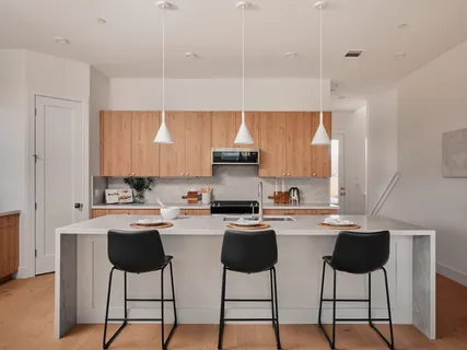a dining room with furniture and a floor to ceiling window