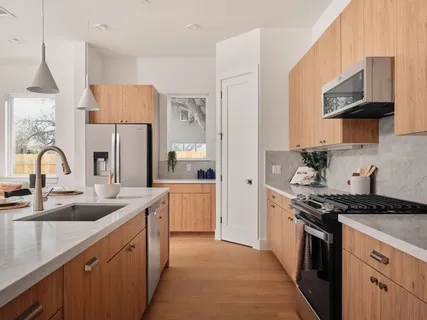 a kitchen with a sink and a stove top oven