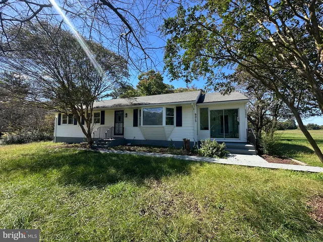 a view of a house with backyard sitting area and fire pit