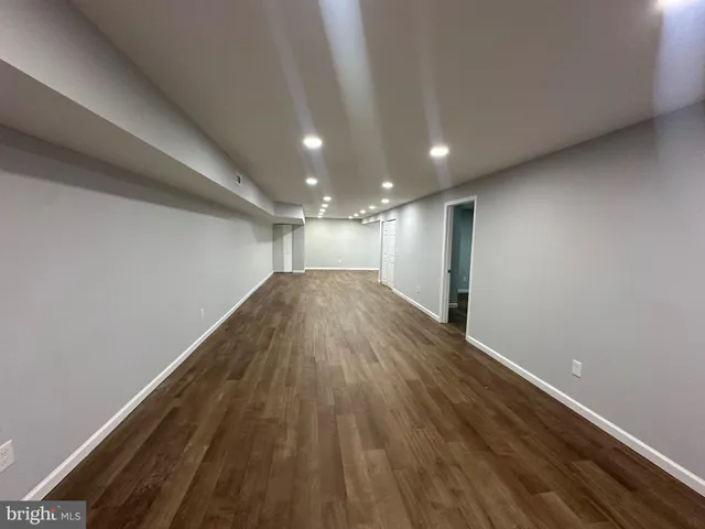 a view of hallway with wooden floor