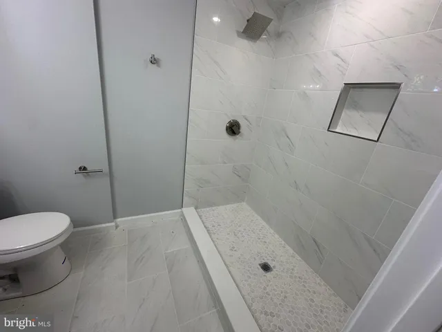 a bathroom with a toilet and shower