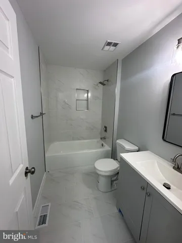 a bathroom with a toilet a sink and bathtub