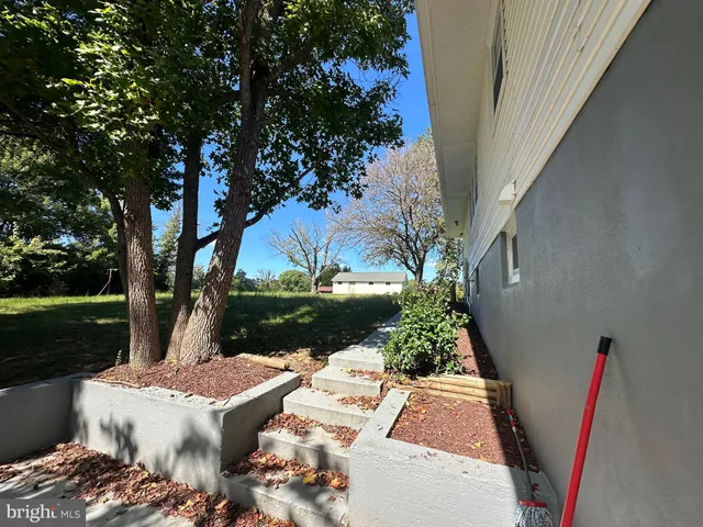 a view of a backyard with sitting area