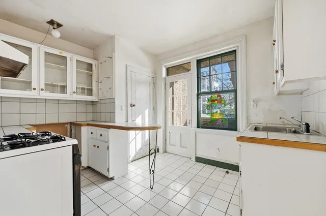 a kitchen that has a sink and a stove