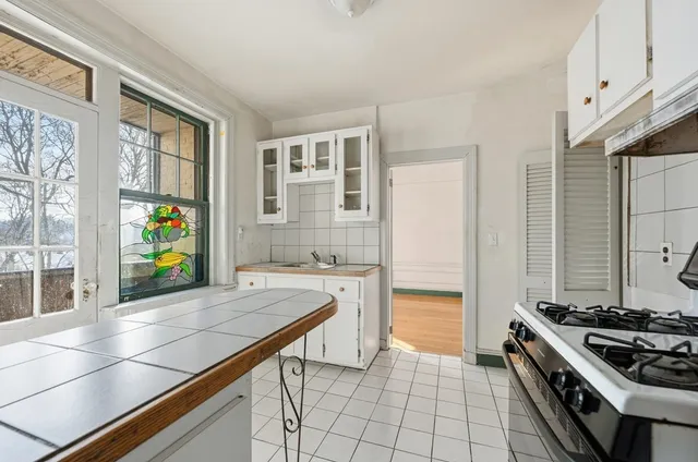 a kitchen with stainless steel appliances a stove a sink and a refrigerator