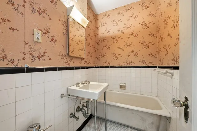 a bathroom with a bathtub and shower
