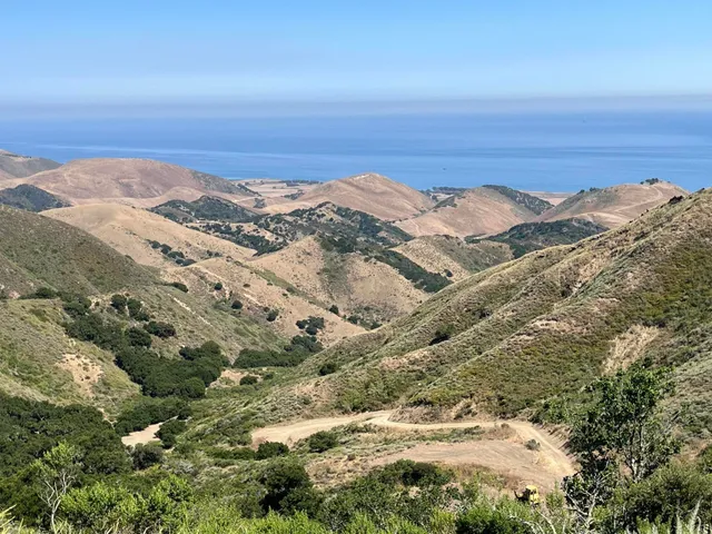 an aerial view of mountain with beach