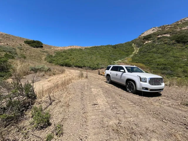 a view of a car parked on the side of a road