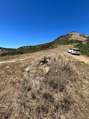 a view of a large mountain with mountains in the background
