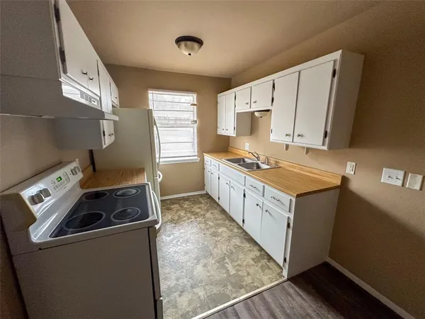 a kitchen that has a sink and a stove