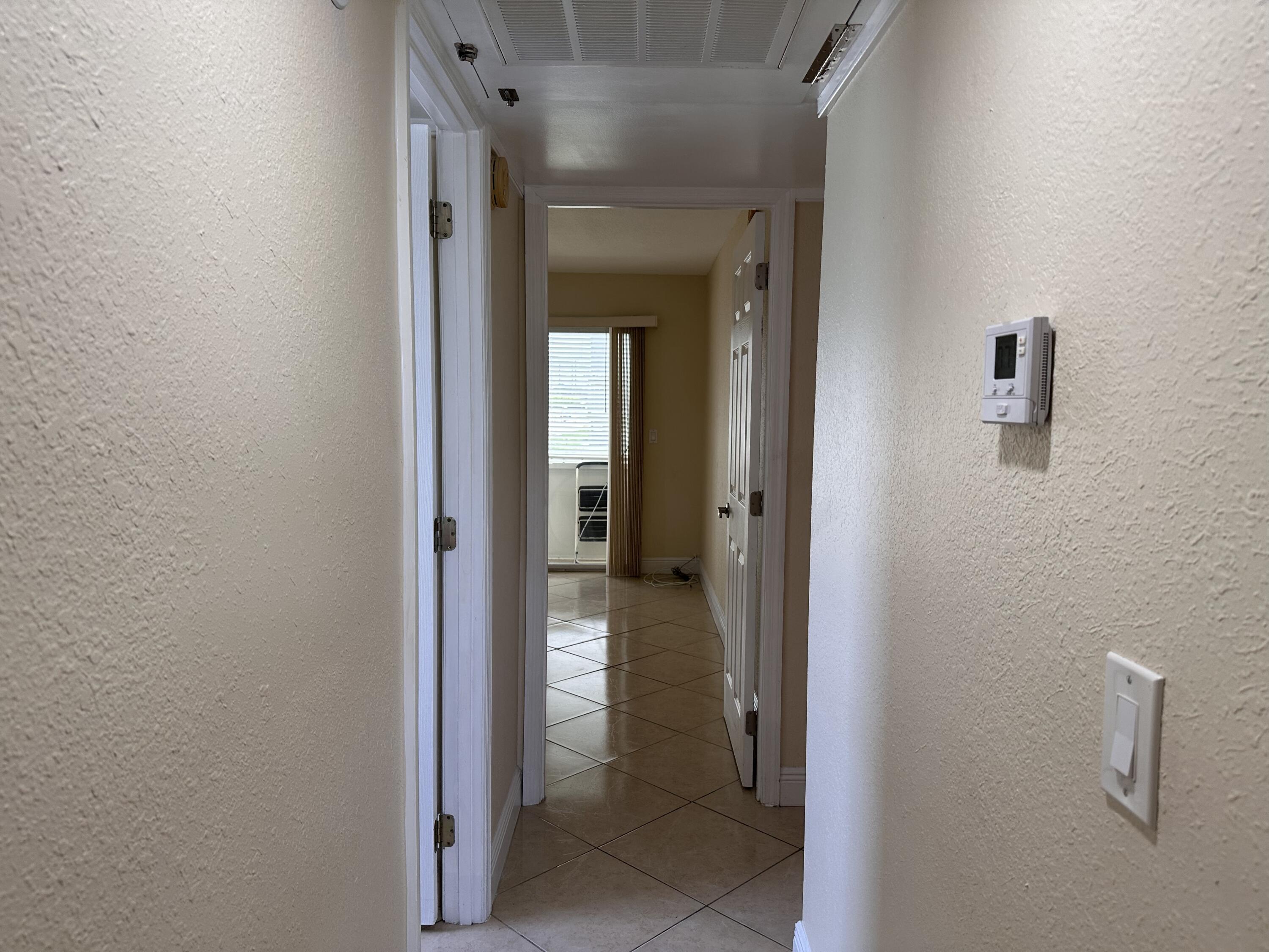 433 Saxony Way Delray Beach, FL 33446 - Photo 16 of 49 a view of a bathroom from a hallway