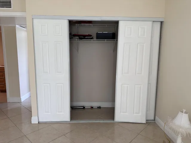 a view of walk in closet with empty racks