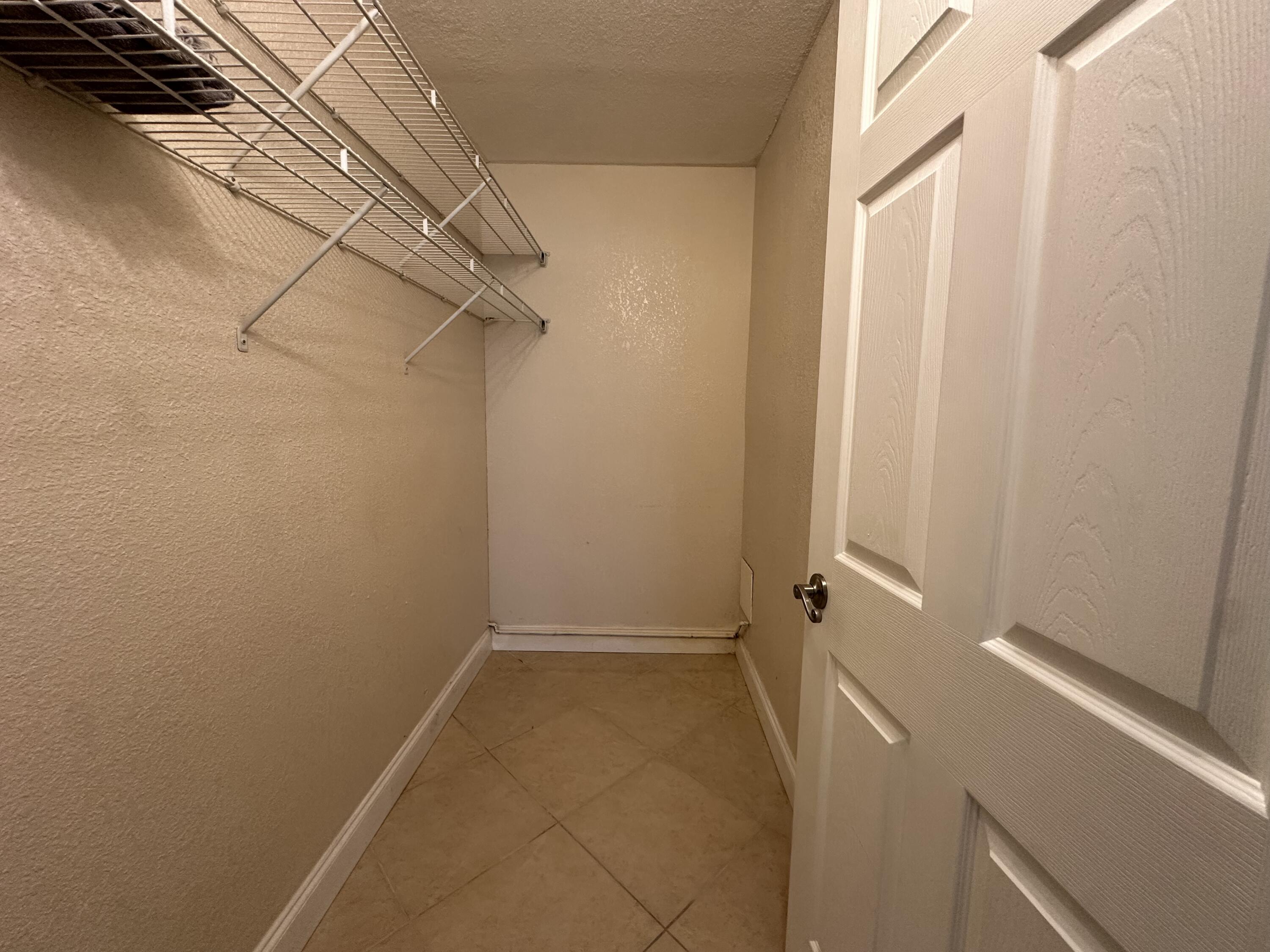 433 Saxony Way Delray Beach, FL 33446 - Photo 32 of 49 a view of a room with racks on the wall