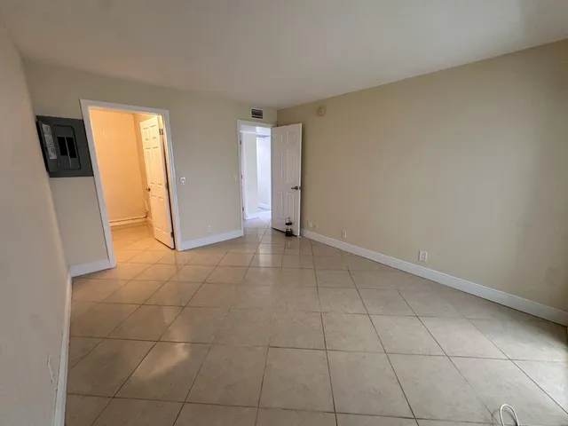 a view of an empty room with a fireplace