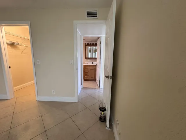 a view of a hallway to rooms and a room