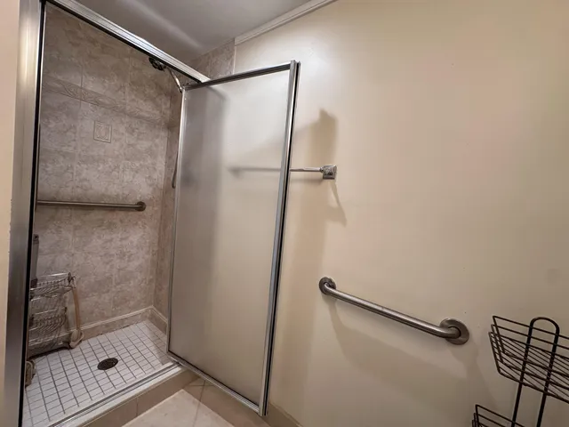 a bathroom with a glass shower door