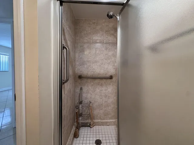 a bathroom with a glass shower door