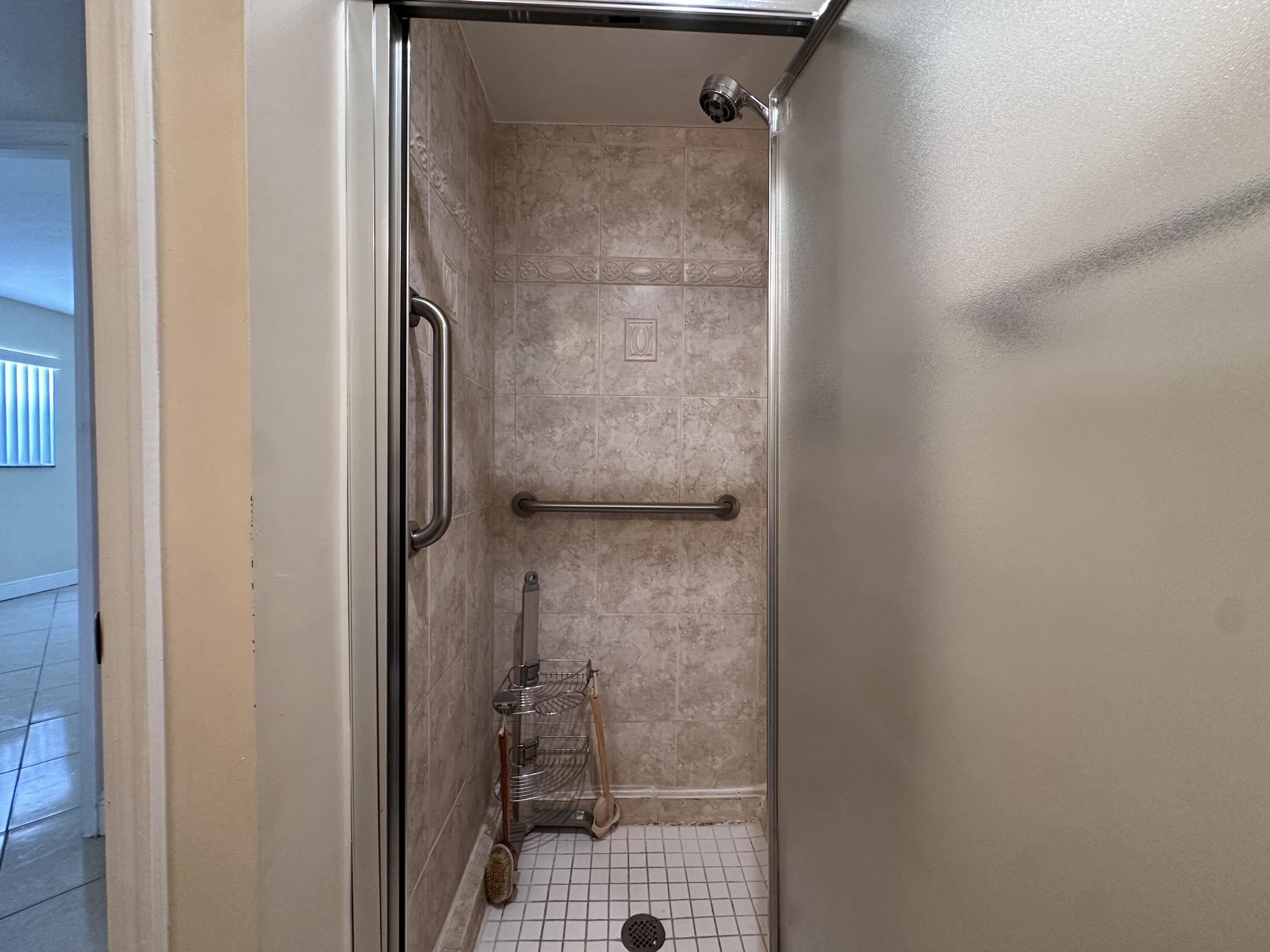 433 Saxony Way Delray Beach, FL 33446 - Photo 42 of 49 a bathroom with a glass shower door