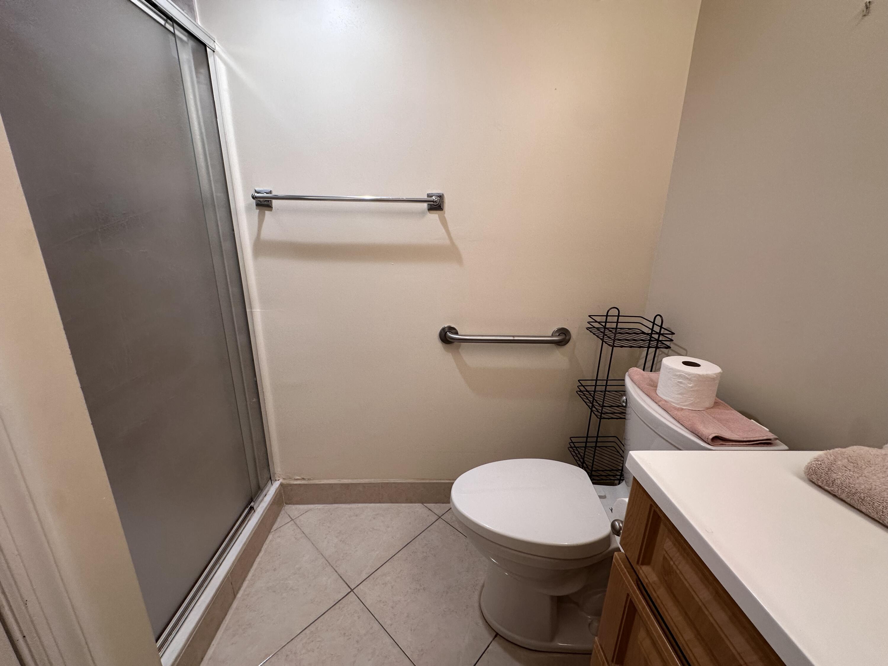 433 Saxony Way Delray Beach, FL 33446 - Photo 44 of 49 a white toilet sitting next to a shower