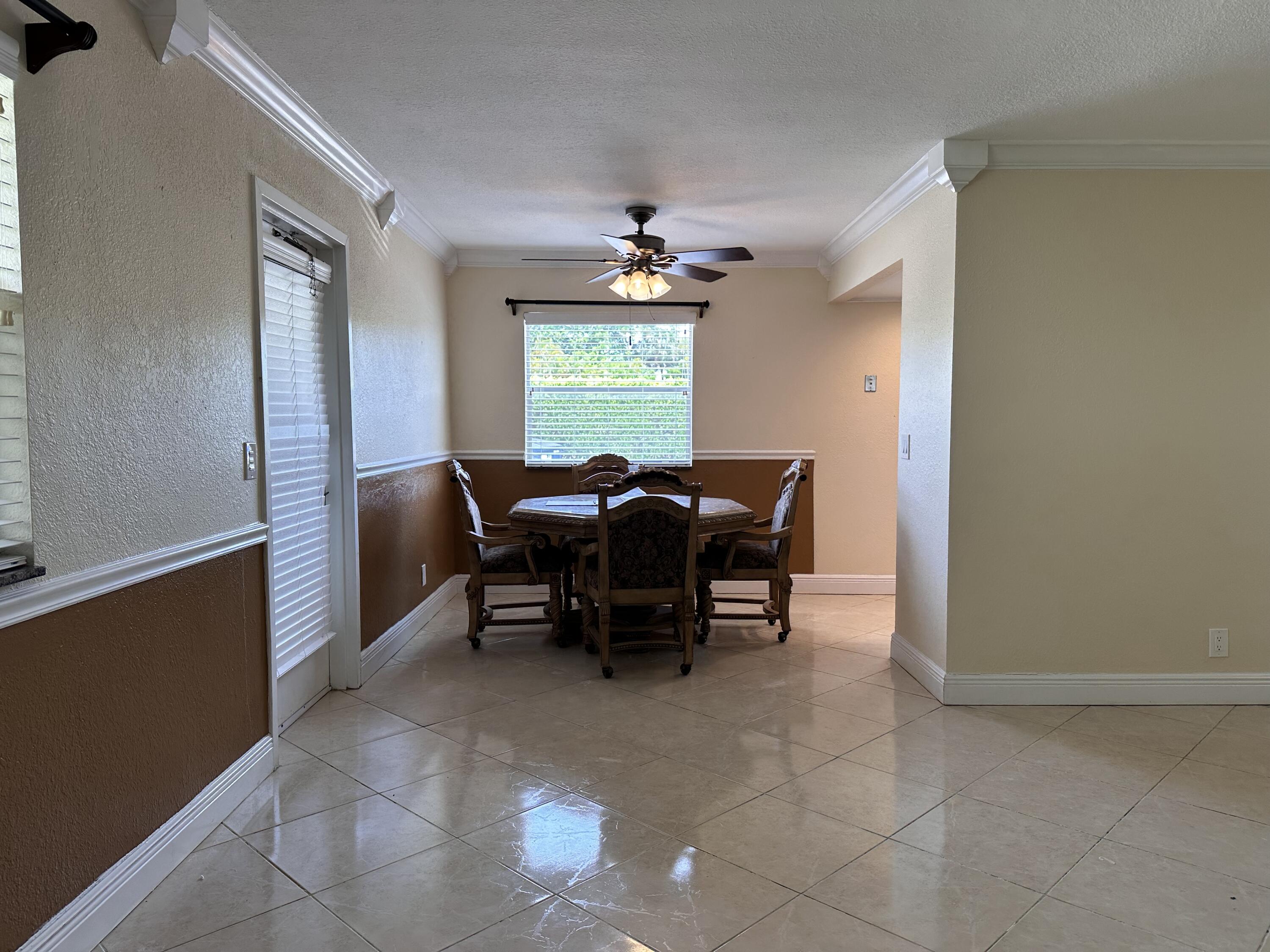 433 Saxony Way Delray Beach, FL 33446 - Photo 6 of 49 a view of a dining room with furniture and window