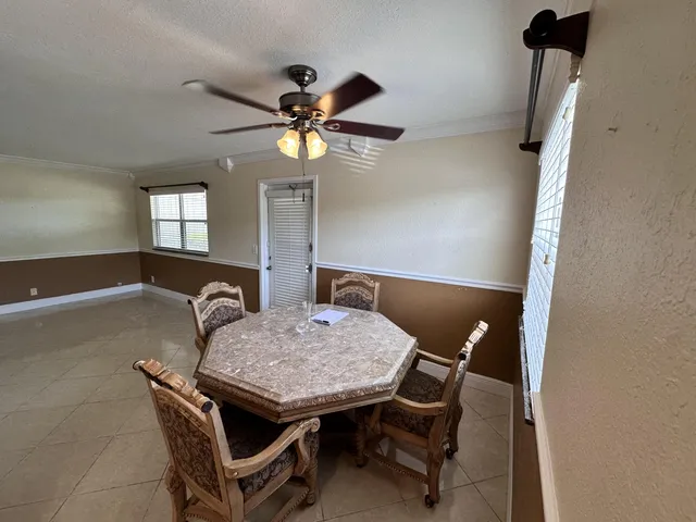 a dining room with furniture and window