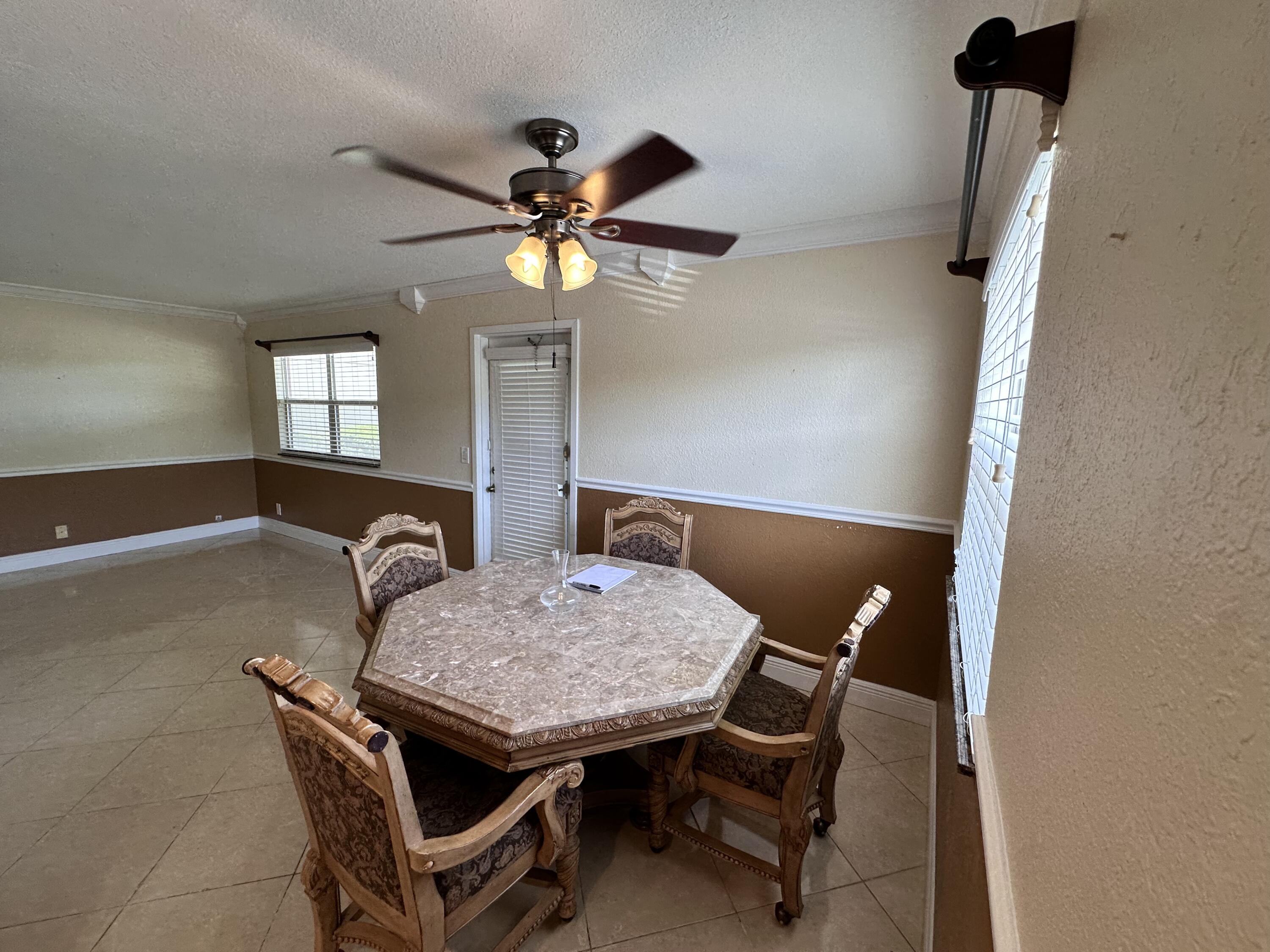 433 Saxony Way Delray Beach, FL 33446 - Photo 9 of 49 a dining room with furniture and window