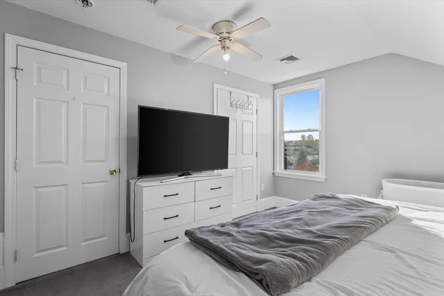 a bedroom with a bed and a flat screen tv