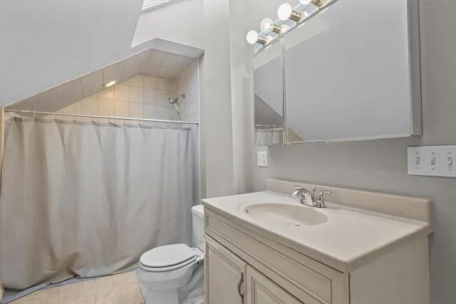 a bathroom with a sink toilet and a mirror
