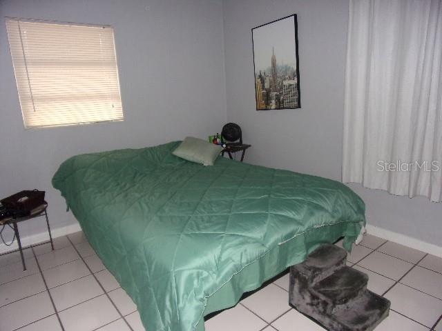 3226 Independence Avenue Lakeland, FL 33803 - Photo 11 of 19 a bed sitting in a bedroom next to a window