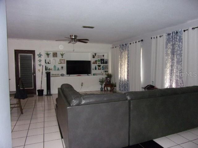 3226 Independence Avenue Lakeland, FL 33803 - Photo 4 of 19 a living room with furniture a flat screen tv and a fireplace