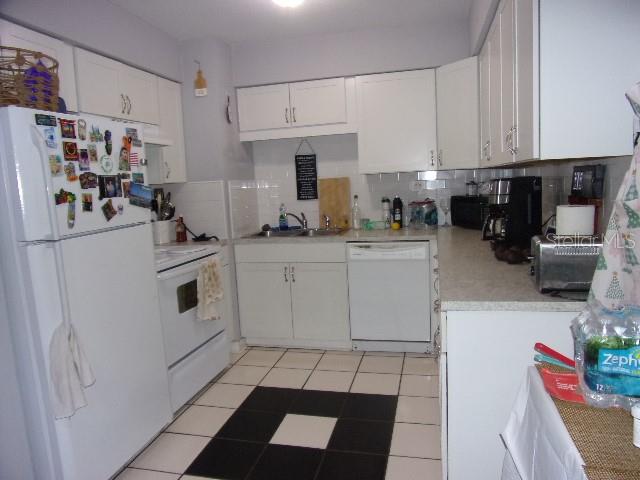 3226 Independence Avenue Lakeland, FL 33803 - Photo 6 of 19 a kitchen with white cabinets and white appliances