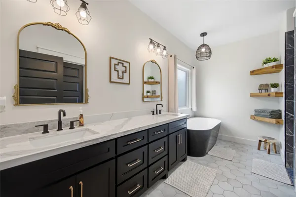 a bathroom with a double vanity sink and a mirror