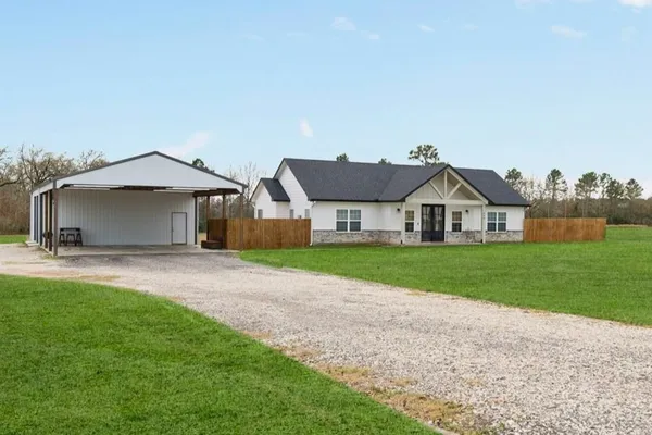a front view of a house with yard and garage